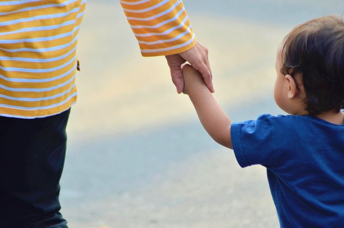 Mother holding childs hand